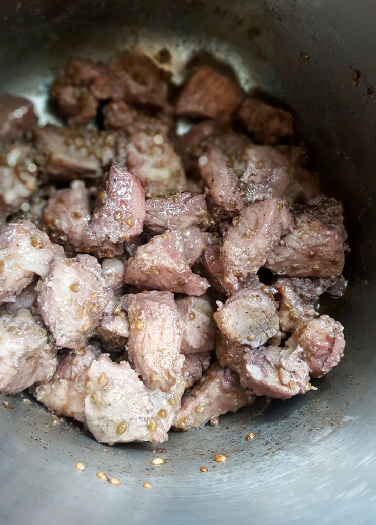 pot of cypriot afelia cooking