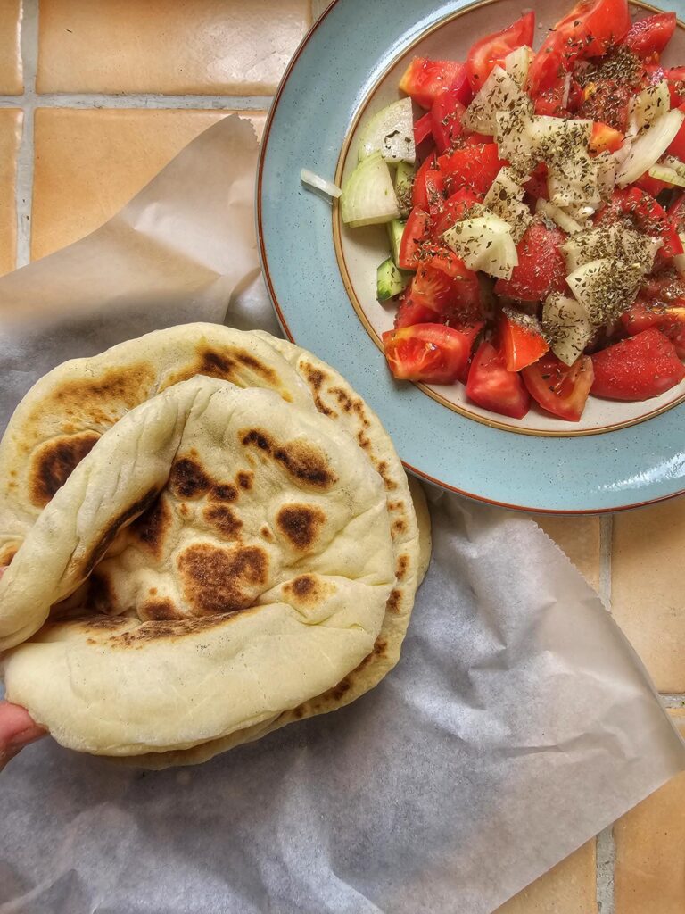 greek pita bread homemade with a side of greek salad