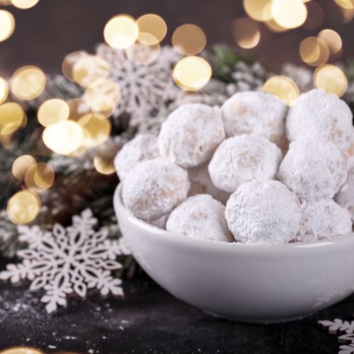 greek christmas cookies kourambiedes in a bowl with christmas decoration