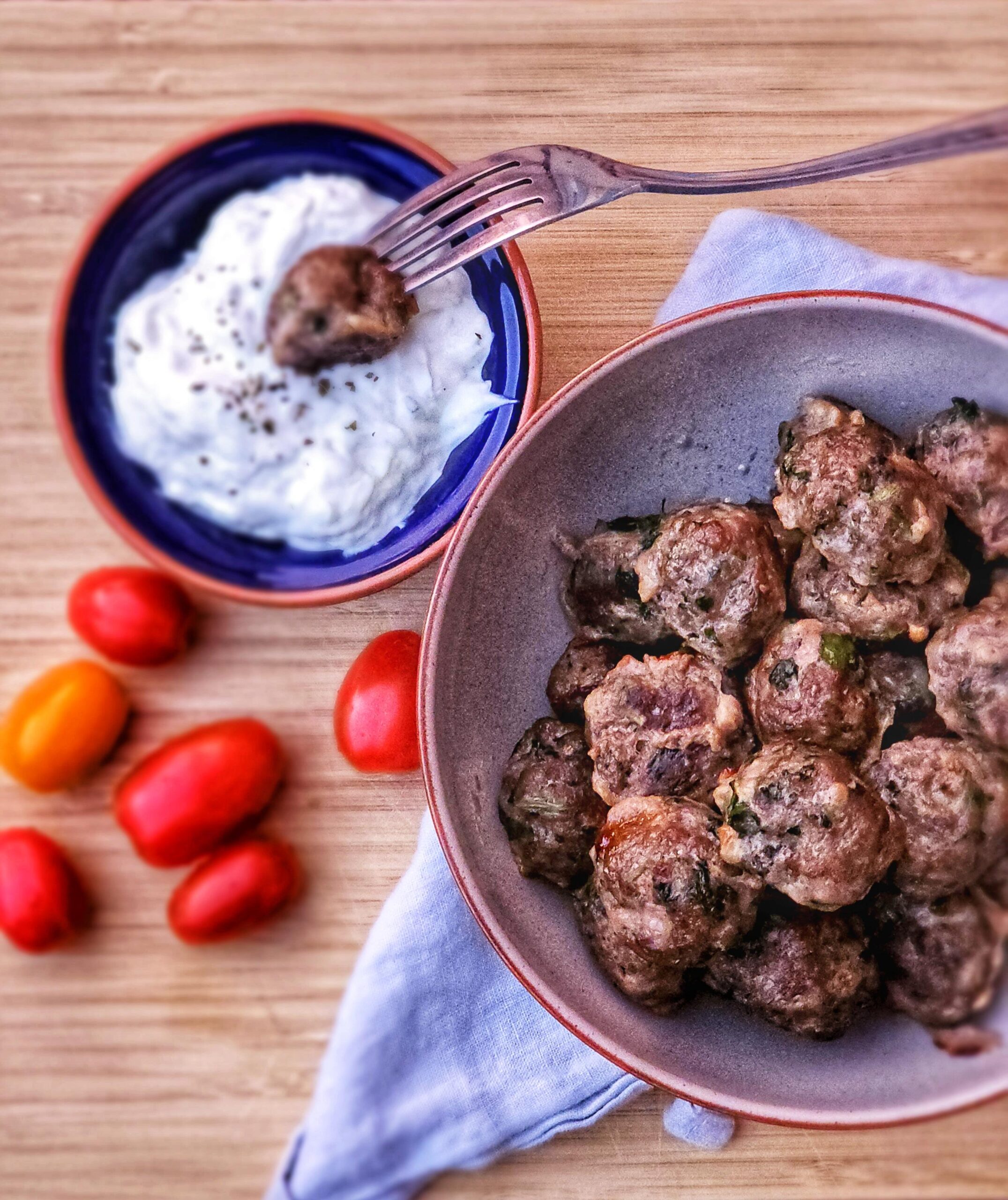 greek meatballs with cherry tomatoes and tzatziki