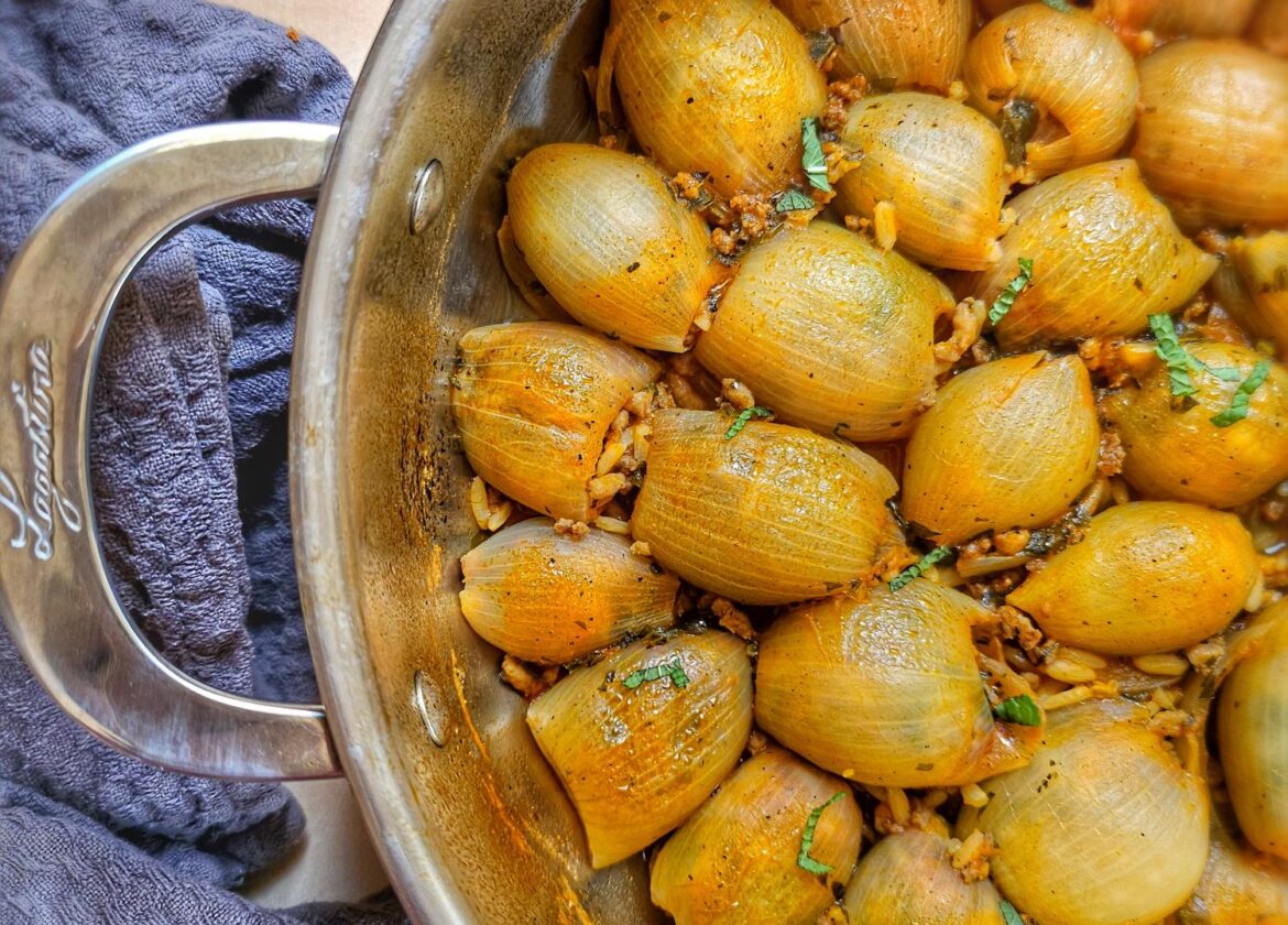 pan filled with huice, yummy greek onions stuffed with minced meat