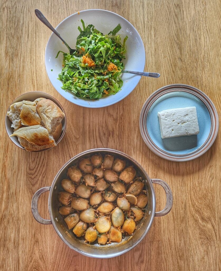 greek stuffed onions served with salad, bread and feta