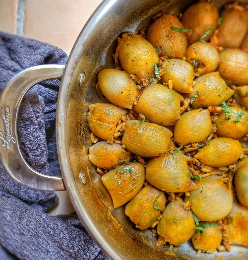 pan filled with huice, yummy greek onions stuffed with minced meat